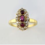 Early 20th C ruby and diamond ring, marquise form, centre with three rubies, surrounded by old cut