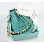 Tiffany & Co silver necklace of graduating spherical beads, length 40 cm, with pouch and box .