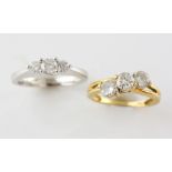 Two diamond rings, a three stone diamond ring, graduated round brilliant cut diamonds, estimated
