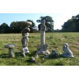 Small collection of composite stone garden ornaments, including figure of a boy seated on top of a