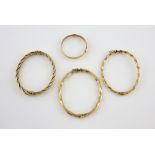 Four gold bangles, three twisted oval hinged bangles, with concealed clasp and figure of eight