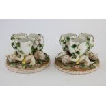 Pair of 19th Century Dresden vases, bases with three reclining putti,10 cm high .