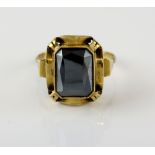 Hematite single stone ring, rectangular faceted hematite, mounted in yellow metal bearing