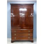19th century mahogany linen press the top with two cupboard doors, the interior with trays, on