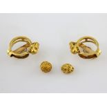 A pair of Etruscan style tiger head clip on earrings, mounted in yellow metal stamped 18 ct,