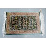Turkish silk rug foliate design on a deep green ground 65cm x 102cm