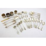 Group of silver items to include four napkin rings, teaspoons, serving spoon, sugar nips, various