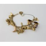 Gold charm bracelet, with heart padlock clasp, measuring approximately 18cm in length, with twenty