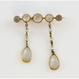 Victorian pendant brooch, bar set with round cabochon moonstones, the two pendant drops with seed