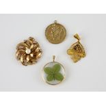 Four pendants, pearl and paste floral twist pendants in yellow metal stamped 18 ct, measuring