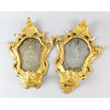 Pair of late 18th/ early 19th Century carved and gilt wood Venetian mirrors, the plates engraved