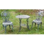 Cast metal garden table diameter 64cm and two matching chairs