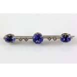 Tanzanite and diamond brooch, set with central tanzanite estimated at 1.24 carats and two oval