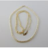 Two pearl necklaces, one graduated with cream round pearls, measuring between 3 to 8mm in