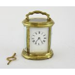 Oval French brass carriage clock, striking on a gong. 16cm