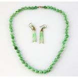 Jade necklace, beads measuring 9mm in diameter, strung with knots, measuring approximately 55cm in