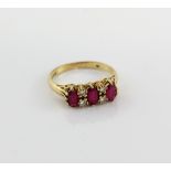 Ruby and diamond ring, three oval cut rubies set with four round brilliant cut diamonds, mounted