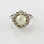 Pearl and diamond ring, set with central half pearl within a border of old cut diamonds, 18 ct white