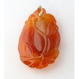 Chinese agate pendant, carved in the form of a plum with leaves, measuring approximately 7 x 3.