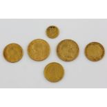 Two George V sovereigns 1911 and 1910, three half sovereigns 1910, 1891, and 1887 and a 1$ charm.