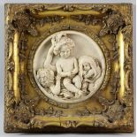 Two reconstituted marble plaques, in gilt gesso frames, 17cm dia.