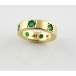 Modern emerald dress ring, set with six round cut emeralds, estimated total weight 1.15 carats,