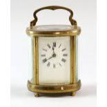 Brass and glass oval carriage clock with lever escapement 16 cm