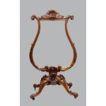19th century heavily carved walnut firesreen of lyre shape inset with a glass central panel, the