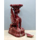19th century red glazed ceramic pedestal in the form of a Griffin 87cm high .
