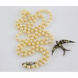 Cultured opera length pearl necklace, round white pearls, measuring approximately 6mm in diameter,