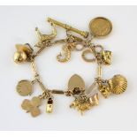 Fancy link gold charm bracelet, measuring approximately , with heart padlock clasp and safety chain,