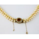 Graduated double row pearl necklace, round cream pearls measuring 9mm to 6mm in diameter, strung