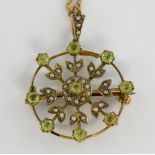 Edwardian pendant brooch and chain, nine round cut peridot stones, with seed pearl set in floral