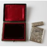 Edwardian silver card case, with bright cut decoration and vacant shield cartouche, in fitted