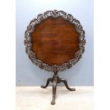George III mahogany round tilt top table with carved and pierced border on column support and tripod