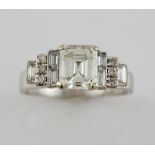 Emerald cut diamond ring,in a raised setting with baguette and brilliant cut diamonds, central stone