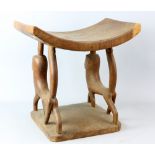 African carved wooden stool, with stylised lion legs, 38 cm wide x 38 cm highPROVENANCE: Acquired by