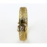 Oval hinged Greek key bangle,with hidden clasp and two figure of eight safety clasps, yellow and