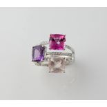 Modern diamond and multi gem set dress ring, with three square cut gems, amethyst, estimated