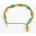 Chinese jade bracelet, cabochon cut jade, alternately set in-between yellow metal links with