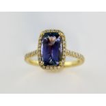 Tanzanite and diamond set ring, the rectangular cut stone estimated at 2.08 carat, within a border