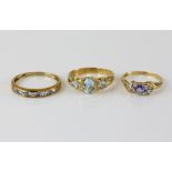 Three gem set rings, blue topaz and diamond ring, with a central oval cut and two round cut blue