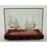 A silver filigree model of two tropical fish, stamped 925, in a glass-covered case, fish measuring