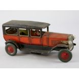 Tinplate clockwork car in the form of a red and black limousine with chauffeur, electric front