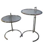 Eileen Gray - pair of modern chrome adjustable side-tables, with circular glass tops, 61 cm high.