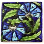 William de Morgan, large double carnation tile, painted on a blue ground, impressed mark, 20.7 x