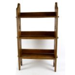 A Liberty & Co. Arts and Crafts oak three-tier ‘Sedley’ bookcase with pegged shelves and pieced