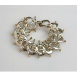 Brett Payne silversmith, bracelet, of interconnecting horse shoe links, with gold plated finials,