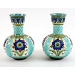 A pair of Burmantofts Faience Partie-Colour vases with rounded body and flared neck designed by
