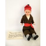 Victorian wax-headed doll with brown glass eyes, with cloth body and pottery feet, in a brown